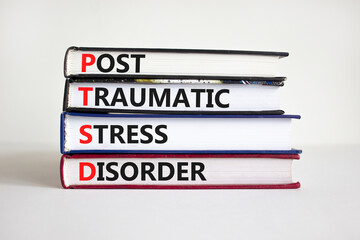 PTSD, post-traumatic stress disorder symbol. Concept words 'PTSD, post-traumatic stress disorder' on books on a beautiful white background. Medical and PTSD concept. Copy space. - obrazy, fototapety, plakaty
