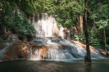 Sai Yok Noi waterfall flowing on limestone in tropical rainforest at national park