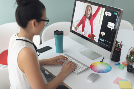 Caucasian girl using laptop for video call, with smiling biracial elementary school pupil on screen
