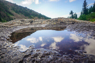 Small puddle on a stone in the Siberian mountains