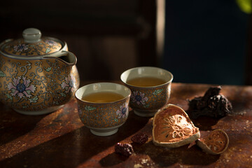 Close up view of nice china teapot and glasses on color back