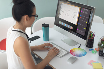 Asian woman using computer for video call, with class on screen