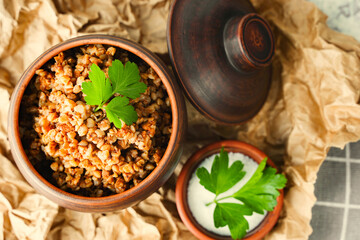 A pot of buckwheat porridge close up. Balanced nutrition, anti-crisis food. Diet healthy lunch or lunch. Rustic style