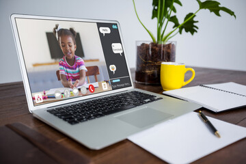 Smiling african american girl during class on laptop screen