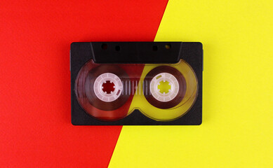 Tape cassette on red and yellow background