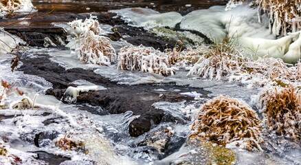 Fast river with ice in late autumn