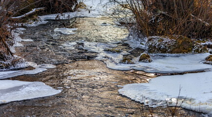Fast river with ice in late autumn