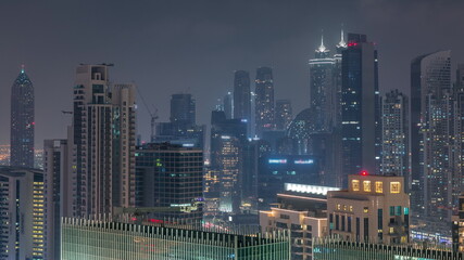 Dubai skyscrapers with illumination in business bay district night timelapse.