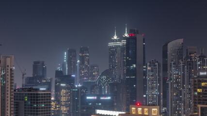 Fototapeta na wymiar Dubai skyscrapers with illumination in business bay district during all night timelapse.
