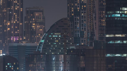 Fototapeta na wymiar Dubai skyscrapers with illumination in business bay district night timelapse.