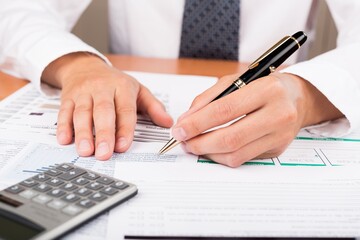 Fototapeta premium Close-up of a Businessman Analyzing Financial Figures
