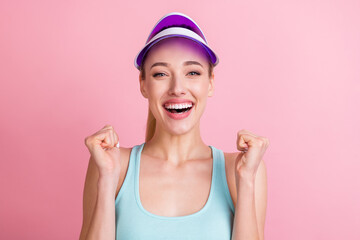 Photo of hooray blond young lady hands fists yell wear blue top visor isolated on pink color background