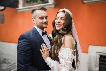 Romantic wedding moment, couple of newlyweds smiling portrait, bride and groom hugging