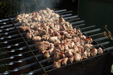 Meat on skewers is fried on the grill