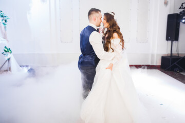 Beautiful wedding couple just married and dancing their first dance