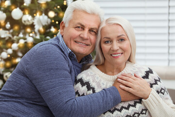 Fototapeta premium Happy mature couple at home. Christmas celebration