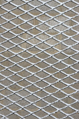 Many cells of chain-link fence are covered with fresh snow.