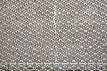 Many cells of chain-link fence are covered with fresh snow.