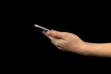 Closeup of hand using mobile phone against black background photo