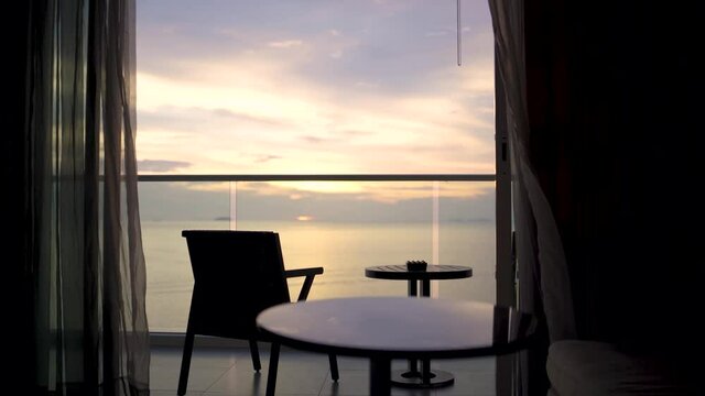Seaside room balcony at sunset time.