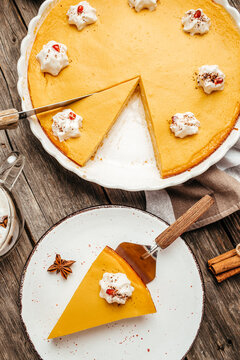 Festive pumpkin pie with whipped cream. vertical image. top view. place for text