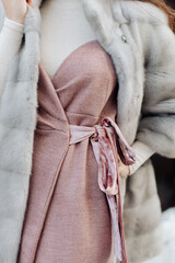 dress and white fur coat on a girl close-up