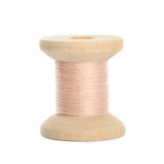 Wooden spool of pale pink sewing thread isolated on white