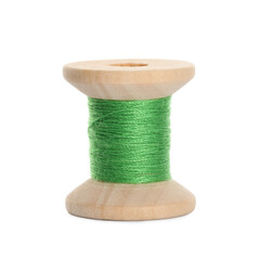 Wooden spool of light green sewing thread isolated on white