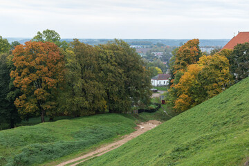 Fototapeta na wymiar Green hills and yellowed autumn trees