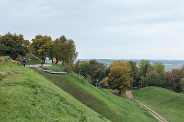 Fototapeta na wymiar Green hills and yellowed autumn trees