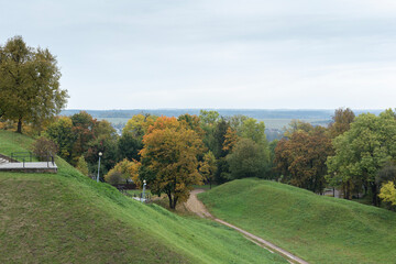 Plakat Green hills and yellowed autumn trees