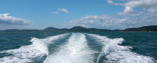 Wake from speedboat and islands in Setouchi Inland Sea,...