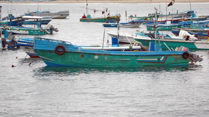 Fototapeta premium Fishing boats moored in the harbor in Puerto Lopez, Ecuador
