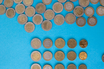 Euro coins lie on a blue background for business investment attraction concept