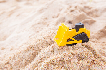 bulldozer toy yellow plastic beach sand