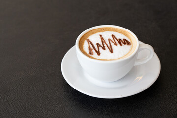 Latte coffee or cappuccino coffee in white cup with latte art