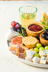 Cheese Board Various Cheese Olives,Figs Fruits, Grapes, Wine and Nuts