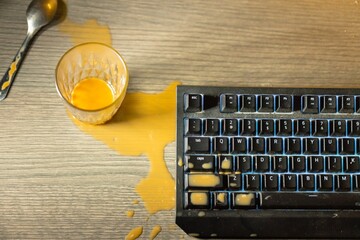 Coffee spilled on mechanical keyboard of computer