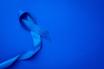 Ribbon cancer. Awareness of men health in November with blue prostate cancer ribbon isolated on...