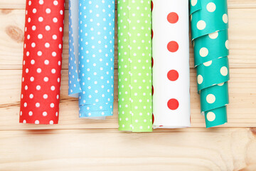 Rolls of craft papers on wooden background