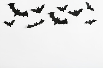 Halloween paper bats on grey background