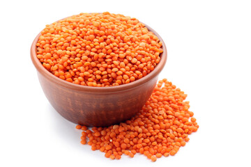 Red lentils with bowl isolated on white background