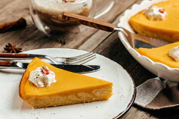 Fresh Pumpkin Pie with whipped cream on plate. Homemade pastry for Thanksgiving