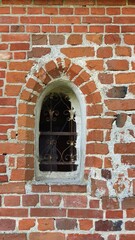 Early gothic window in a small country church, Gothic red brick architecture in the Baltics.
