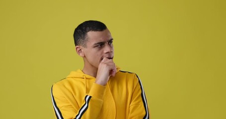 Confused man coming up with a good idea over yellow background