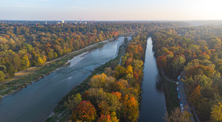 Aerial views of autumn in Munich. Isar river seen from above with colorful trees nearby