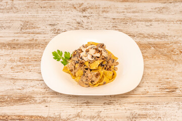 Italian pappardelle pasta cooked with raw and stewed mushrooms