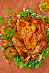 Baked turkey garnished with caramel apples and clover leaves.