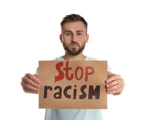 Young man holding sign with phrase Stop Racism on white background
