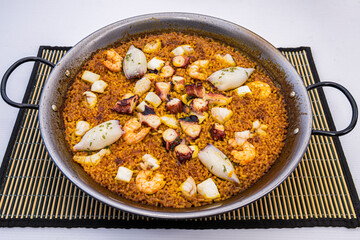 fantastic Spanish paella of seafood and cephalopods with octopus, prawns, squid, squid and socarrat rice on paella pan